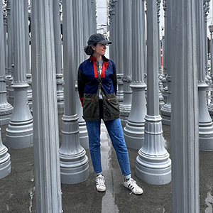 Elizabeth Saubestre standing within Chris Burden's "Urban Light" currently on public view in the Smidt Welcome Plaza, Los Angeles County Museum of Art